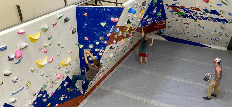 View of students at the bouldering wall in the NMT gym